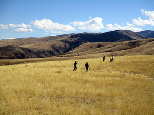 Small group of people walking in open rangeland