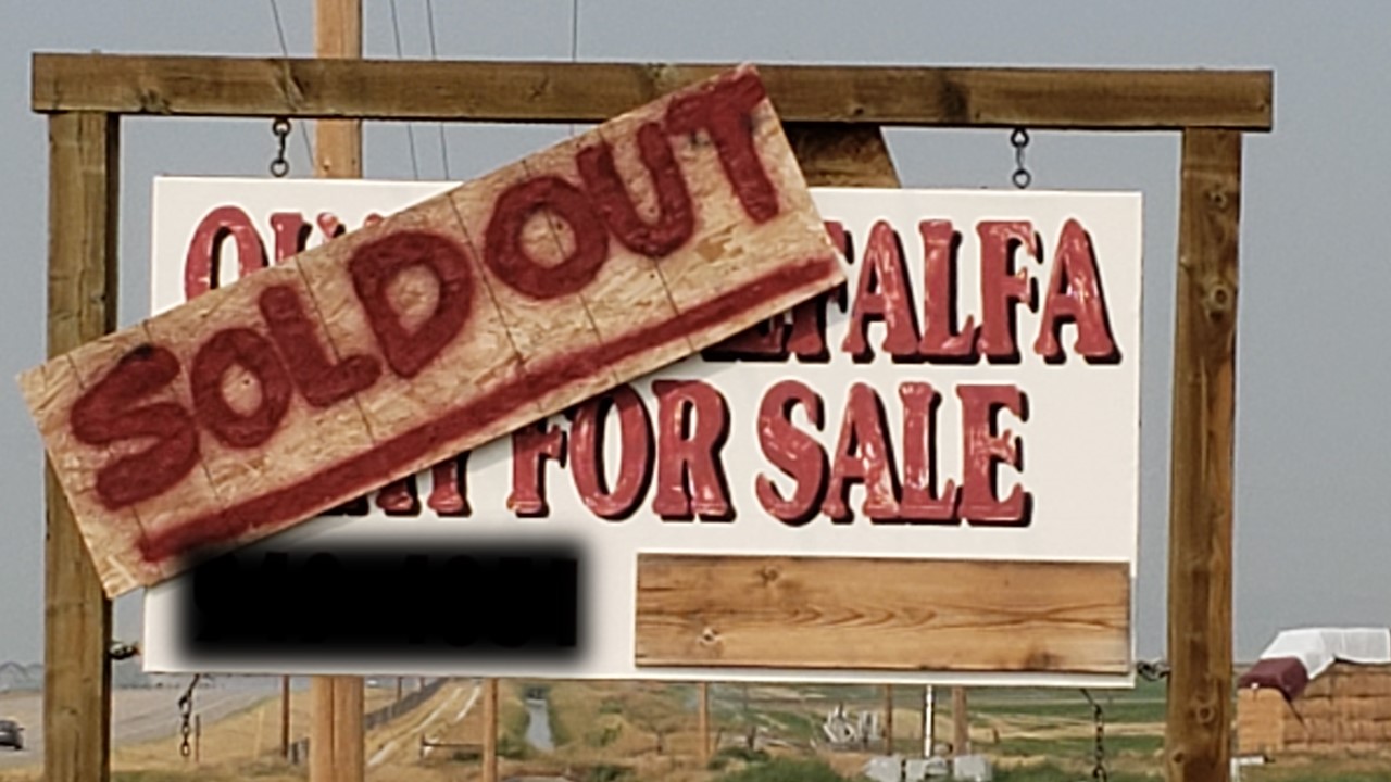 Sign indicating that quality alfalfa hay for sale is now sold out